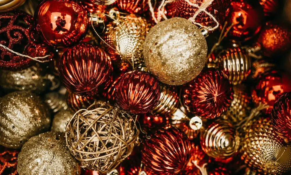 shallow focus photo of gold and red Christmas baubles