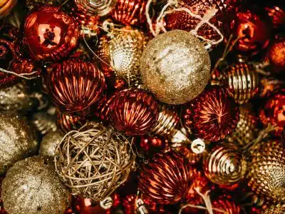 shallow focus photo of gold and red Christmas baubles