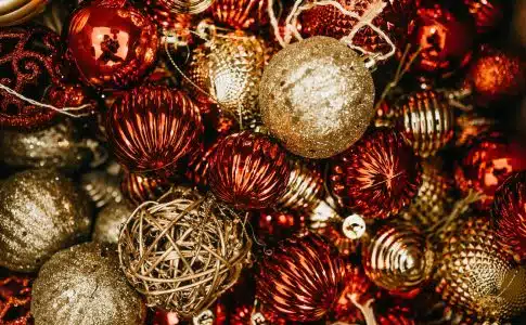 shallow focus photo of gold and red Christmas baubles