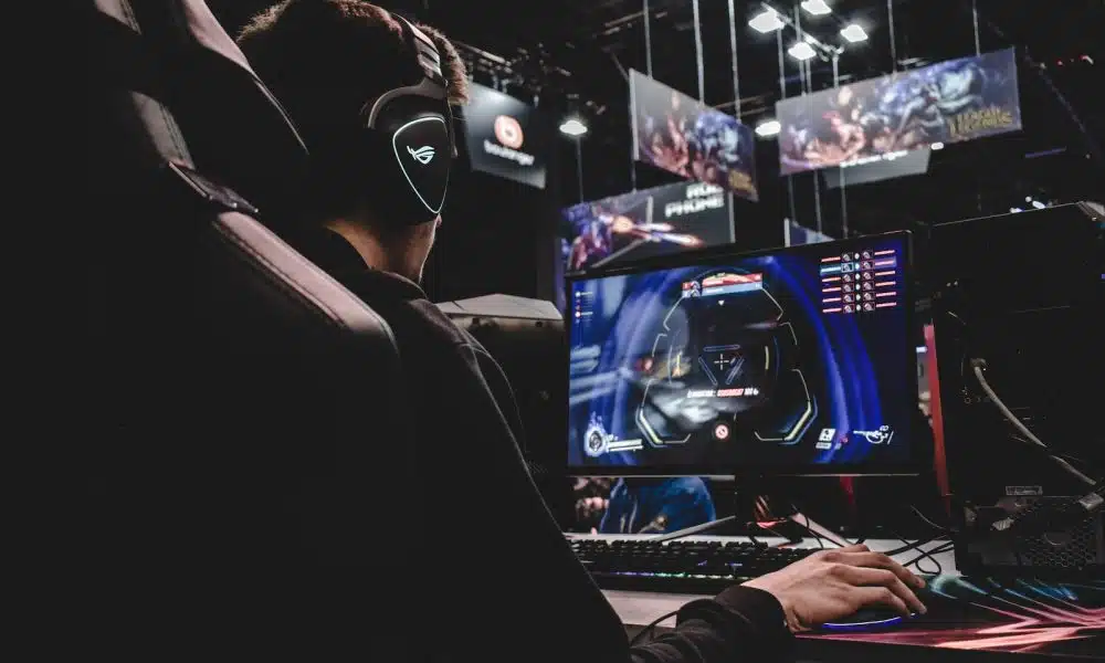 person sitting on gaming chair while playing video game