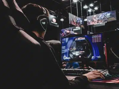 person sitting on gaming chair while playing video game